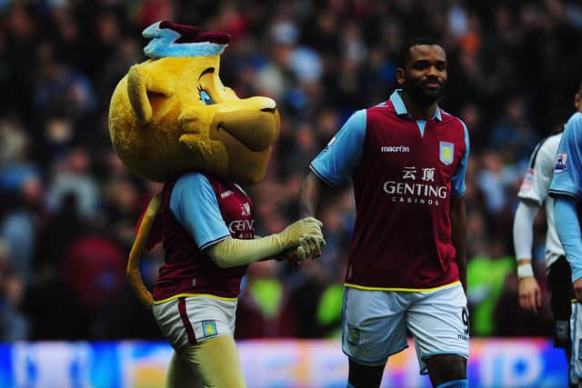 BIRMINGHAM, ENGLAND - JANUARY 05:  Aston Villa mascot Bella shakes hands with striker Darren Bent prior to the FA Cup with Budweiser Third Round match between Aston Villa and Ipswich Town at Villa Park on January 5, 2013 in Birmingham, England.  (Photo by Stu Forster/Getty Images)