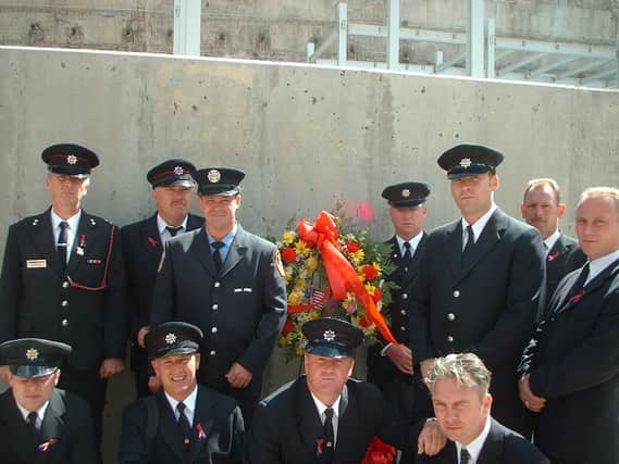  Paul Smith (bottom row right centre) and Andy Horan (bottom row left centre), with fellow firefighters laying the wreath at ground zero on the first anniversary of 9/11