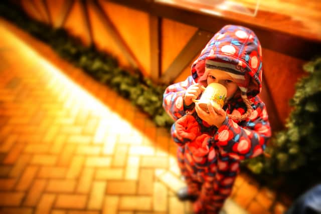 A young girl wraps up warm to enjoy a mug of hot chocolate during Birmingham’s Frankfurt Christmas market on December 3, 2013   (Photo by Christopher Furlong/Getty Images)