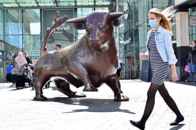  A shopper wearing a protective face mask walks past the Bull statue outside the Bullring shopping centre in Birmingham, central England on August 22, 2020 (Photo by JUSTIN TALLIS / AFP) (Photo by JUSTIN TALLIS/AFP via Getty Images)