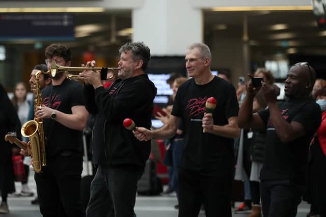 The cast from Dirty Dancing at the Alexandra Theatre entertain crowds at Birmingham New Street