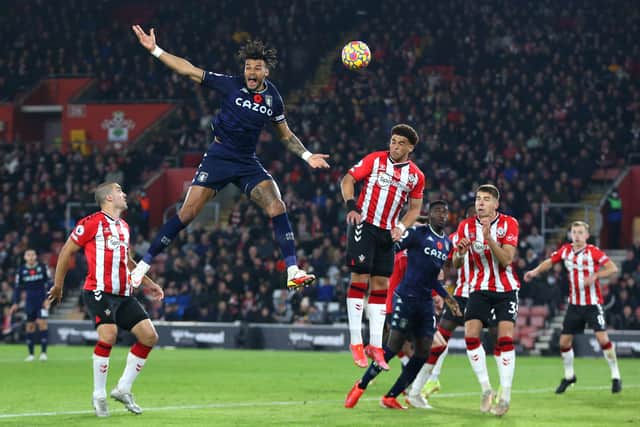 Tyrone Mings of Aston Villa reacts as he competes for a header with Che Adams of Southampton during the Premier League match between Southampton and Aston Villa