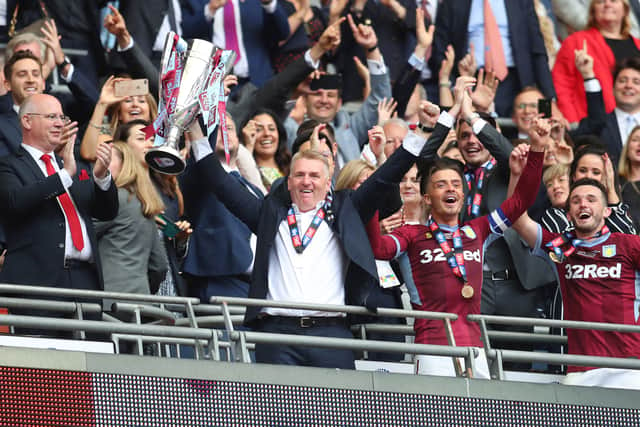 Dean Smith of Aston Villa lifts the trophy with his team following victory in the Sky Bet Championship Play-off Final match between Aston Villa and Derby County