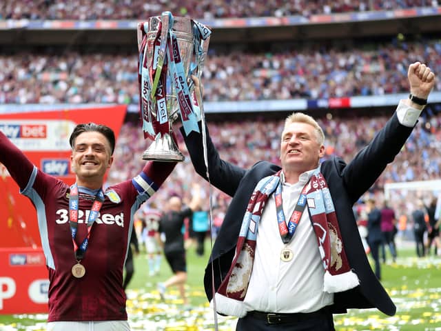 Jack Grealish of Aston Villa lifts the trophy with Dean Smith of Aston Villa following victory in the Sky Bet Championship Play-off Final match between Aston Villa and Derby County at Wembley Stadium