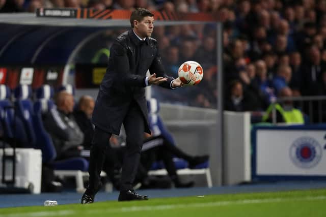 Steven Gerrard, Head Coach of Rangers throws the match ball during the UEFA Europa League group A match between Rangers FC and Olympique Lyo