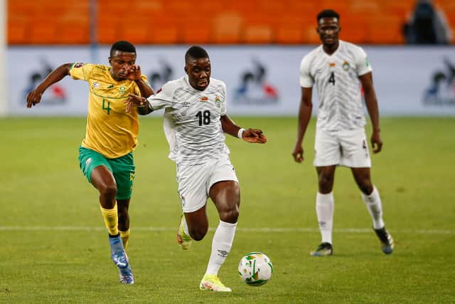 South Africa's Teboho Mokoena (L) vies with Zimbabwe's Marvelous Nakamba (C) during the FIFA World Cup Qatar 2022 qualifying round Group G football match between South Africa and Zimbabwe 