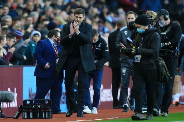 Aston Villa's new English head coach Steven Gerrard (C) applauds supporters as he arrives to take charge of his first game ahead of the English Premier League football match between Aston Villa and Brighton and Hove Albion at Villa Park