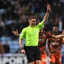 Match referee Leigh Doughty shows a red card to Ryan Woods of Birmingham City (not pictured) during the Sky Bet Championship match between Coventry City and Birmingham City at The Coventry Building Society Arena