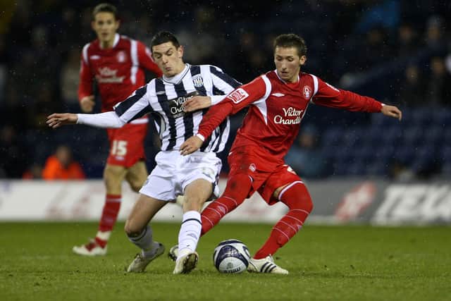 Graham Dorrans of West Bromwich Albion gets tackled by Radoslaw Malewski of Nottingham Forest during the Coca-Cola Football League Championship match between West Bromwich Albion and Nottingham Forest at The Hawthorns