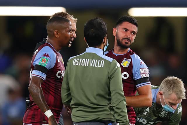 Morgan Sanson of Aston Villa receives medical treatment before being substituted during the Carabao Cup Third Round match between Chelsea and Aston Villa at Stamford Bridge
