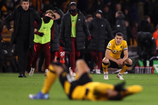 Conor Coady of Wolverhampton Wanderers looks dejected following defeat in the Premier League match between Wolverhampton Wanderers and Liverpool