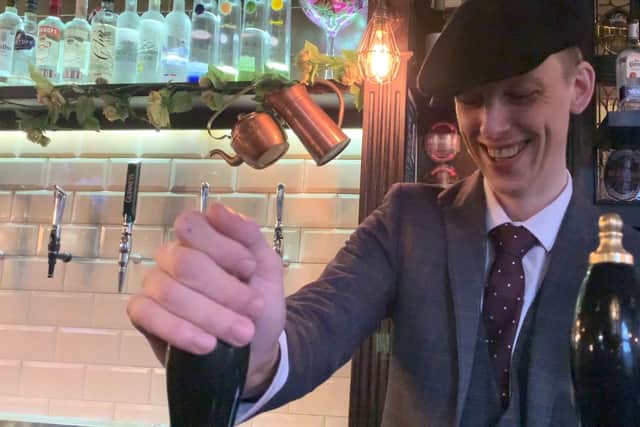Bartender in Bulls Head, Five Ways, Birmingham, pouring Davenports