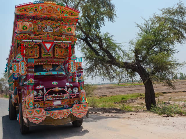 Lahore, Pakistan: A Jingle Truck drives an a small rural road in the countryside