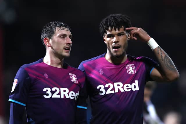 Tyrone Mings of Aston Villa chats with team mate Tommy Elphick during the Sky Bet Championship match between Brentford and Aston Villa at Griffin Par