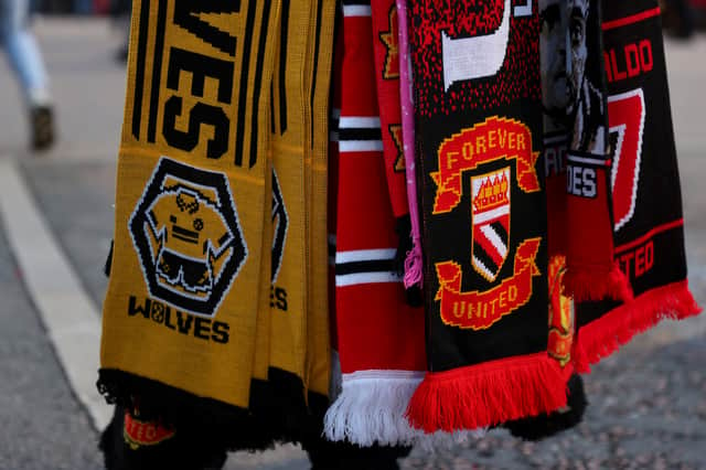 Wolverhampton Wanderers and Manchester United scarves are seen for sale prior to the Premier League match between Manchester United and Wolverhampton Wanderers at Old Trafford