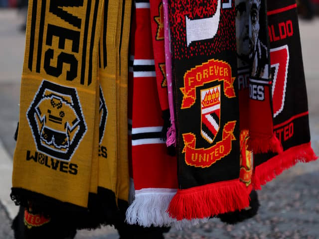 Wolverhampton Wanderers and Manchester United scarves are seen for sale prior to the Premier League match between Manchester United and Wolverhampton Wanderers at Old Trafford