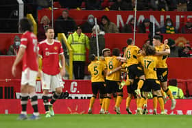 Joao Moutinho of Wolverhampton Wanderers celebrates with teammates  after scoring their side's first goal during the Premier League match between Manchester United and Wolverhampton Wanderers 