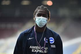 Taylor Richards of Brighton and Hove Albion is seen wearing a face mask as he arrives at the stadium prior to the Premier League match between Burnley and Brighton & Hove Albion