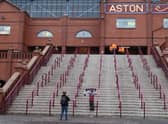Aston Villa fans pose for pictures outside the stadium as the game is postponed due to COVID 19 prior to  the Premier League match between Aston Villa  and  Burnley at Villa Park