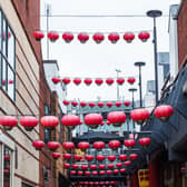 Red lanterns hang above one of the narrow streets which makes up the Chinatown quarter of Birmingham