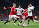 Ollie Watkins of Aston Villa and Emi Buendia of Aston Villa compete for the ball with Scott McTominay of Manchester United and Fred of Manchester United