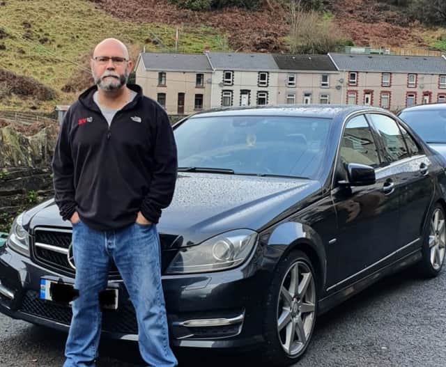 <p>Sean Alabaster with his car after receiving a Birmingham CAZ fine for non-payment</p>