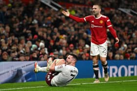 John McGinn of Aston Villa reacts to a tackle from Luke Shaw of Manchester United  during the Emirates FA Cup Third Round match between Manchester United and Aston Villa at Old Trafford 