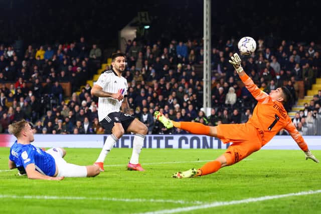 Marc Roberts of Birmingham City (L) scores an own goal to make it the first goal for Fulham during the Sky Bet Championship match between Fulham and Birmingham City at Craven Cottage