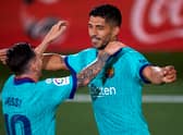 Luis Suarez (R) of Barcelona celebrates with his teammate Lionel Messi 