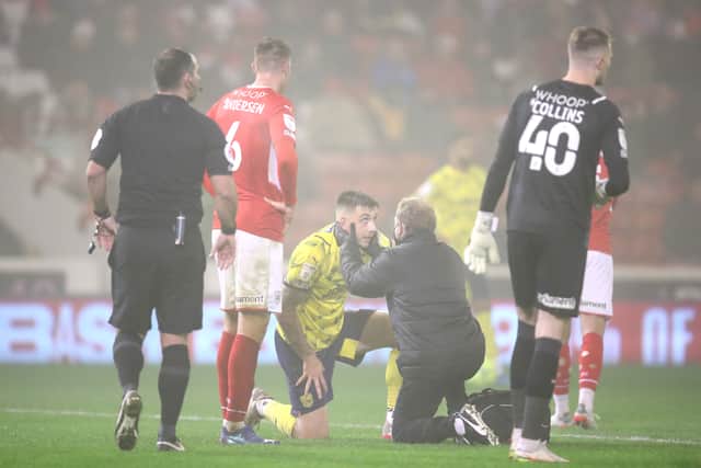 Jordan Hugill of West Bromwich Albion receives medical treatment during the Sky Bet Championship match between Barnsley and West Bromwich Albion at Oakwell Stadium