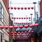 Red lanterns hang above one of the narrow streets which makes up the Chinatown quarter of Birmingham