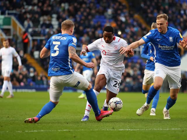 Victor Adeboyejo of Barnsley in action with Kristian Pedersen and Marc Roberts of Birmingham City  during the Sky Bet Championship match between Birmingham City and Barnsley