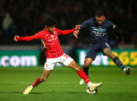 Kaine Kesler of Swindon Town tackles Gabriel Jesus of Manchester City during the Emirates FA Cup Third Round match between Swindon Town and Manchester City at County Ground