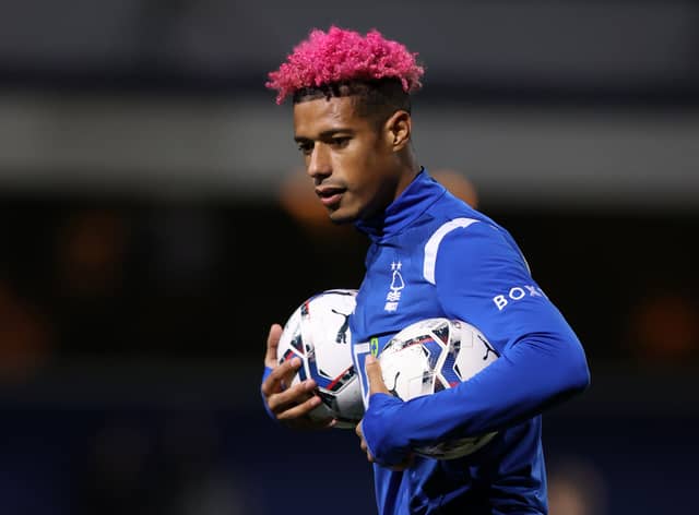  Lyle Taylor of Nottingham Forest with pink hair and pink boots warms up ahead of the Sky Bet Championship match between Queens Park Rangers and Nottingham Forest