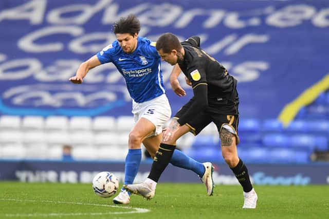 George Friend of Birmingham City is challenged by Lyndon Dykes of Queens Park Rangers during the Sky Bet Championship match between Birmingham City and Queens Park Rangers