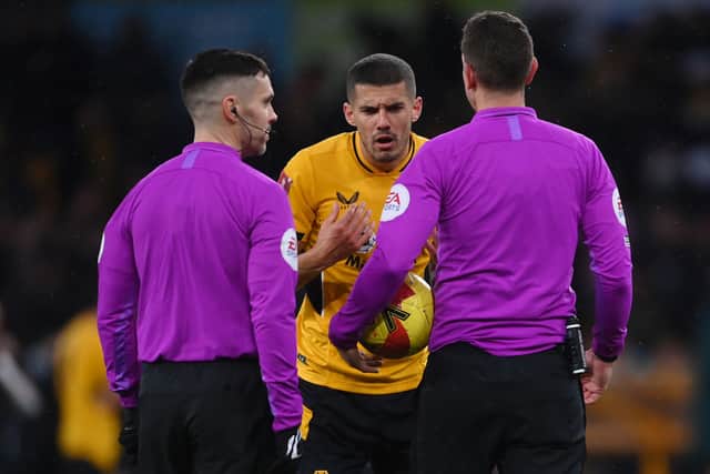 Conor Coady of Wolverhampton Wanderers interacts with referee David Coote during the Emirates FA Cup Fourth Round match between Wolverhampton Wanderers and Norwich City at Molineux on February 05