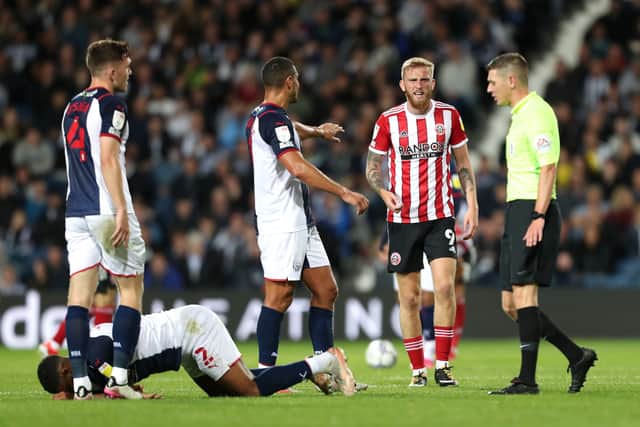 Oliver McBurnie of Sheffield United reacts towards Match Referee, Matthew Donohue after a challenge on Darnell Furlong of West Bromwich Albion