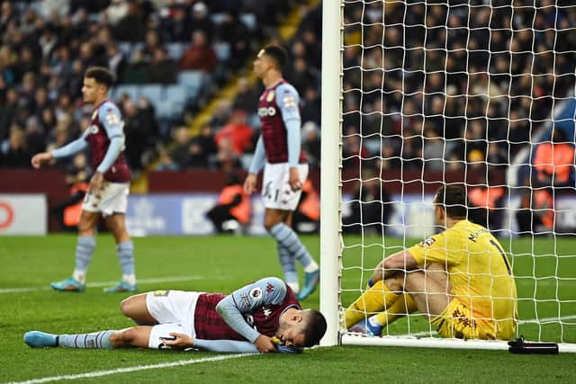 Emiliano Buendia and Emiliano Martinez of Aston Villa react after Daniel James of Leeds United (not pictured) scored their sides second goal (Photo by Clive Mason/Getty Images)