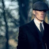 Cillian Murphy as Tommy Shelby, his distinctive flat cap casting a shadow over his face (Credit: BBC/Caryn Mandabach Productions Ltd./Robert Viglasky)