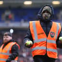 A steward picks up tennis balls thrown on the pitch by Birmingham fans in protest at the club’s owners during the match between Birmingham City and Luton Town at St Andrew’s (Photo by Alex Morton/Getty Images)