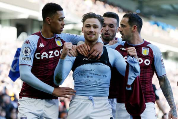 Matty Cash unveils his message of support alongside Villa team-mates. Picture: Henry Browne/Getty Images.