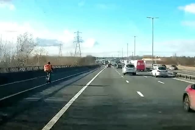  Just Eat cyclist pedals along Spaghetti Junction with delivery pack on his back