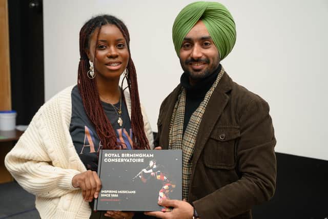 Birmingham City University music industries student Corinne Stewart presents Satinder Sartaaj with a gift from Royal Birmingham Conservatoire 