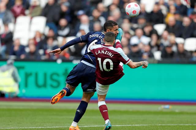 West Ham United's Argentinian midfielder Manuel Lanzini (R) kicks Aston Villa's Brazilian midfielder Douglas Luiz in the face as he attempts an overhead kick during the English Premier League football match between West Ham and Aston Villa