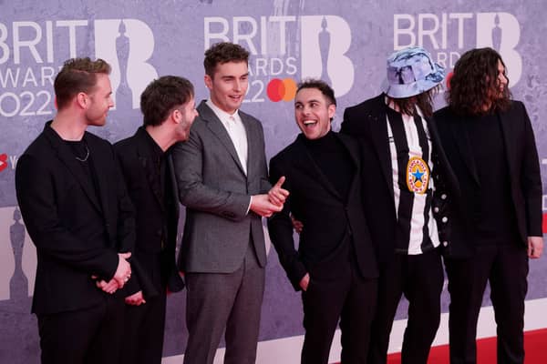 British singer and songwriter Sam Fender (3rd L) poses on the red carpet upon his arrival for the BRIT Awards 2022 in London