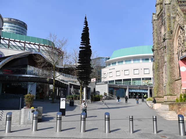 People walk past the Bullring shopping centre in Birmingham a day after Boris Johnson imposed the county’s first lockdown to combat Covid-19 on March 24