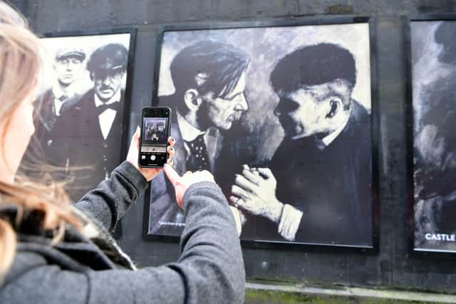 Taking pictures of the Peaky Blinders art on Hill Street 