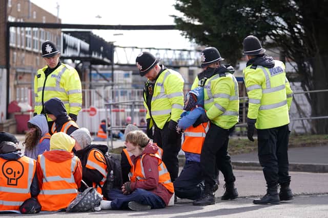 Police remove an activist from Just Stop Oil taking part in a blockade of the ESSO Birmingham Fuel Terminal, Birmingham