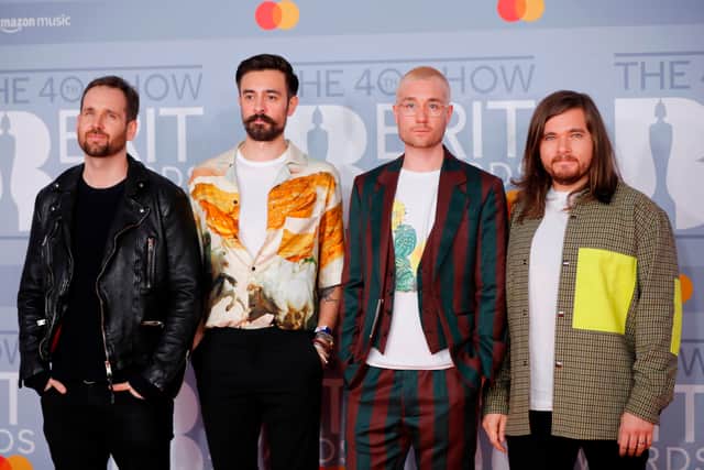 British indie pop band 'Bastille', Dan Smith, Kyle Simmons, Will Farquarson, and drummer Chris Wood  pose on the red carpet on arrival for the BRIT Awards 2020 in London on February 18, 2020. (Photo by Tolga AKMEN / AFP)