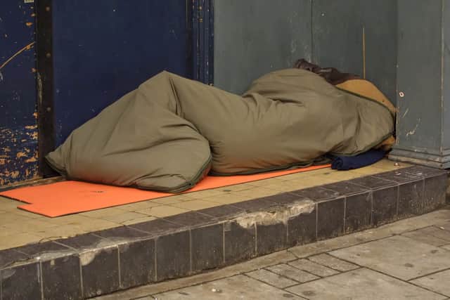 a homeless person sleeping in a doorway